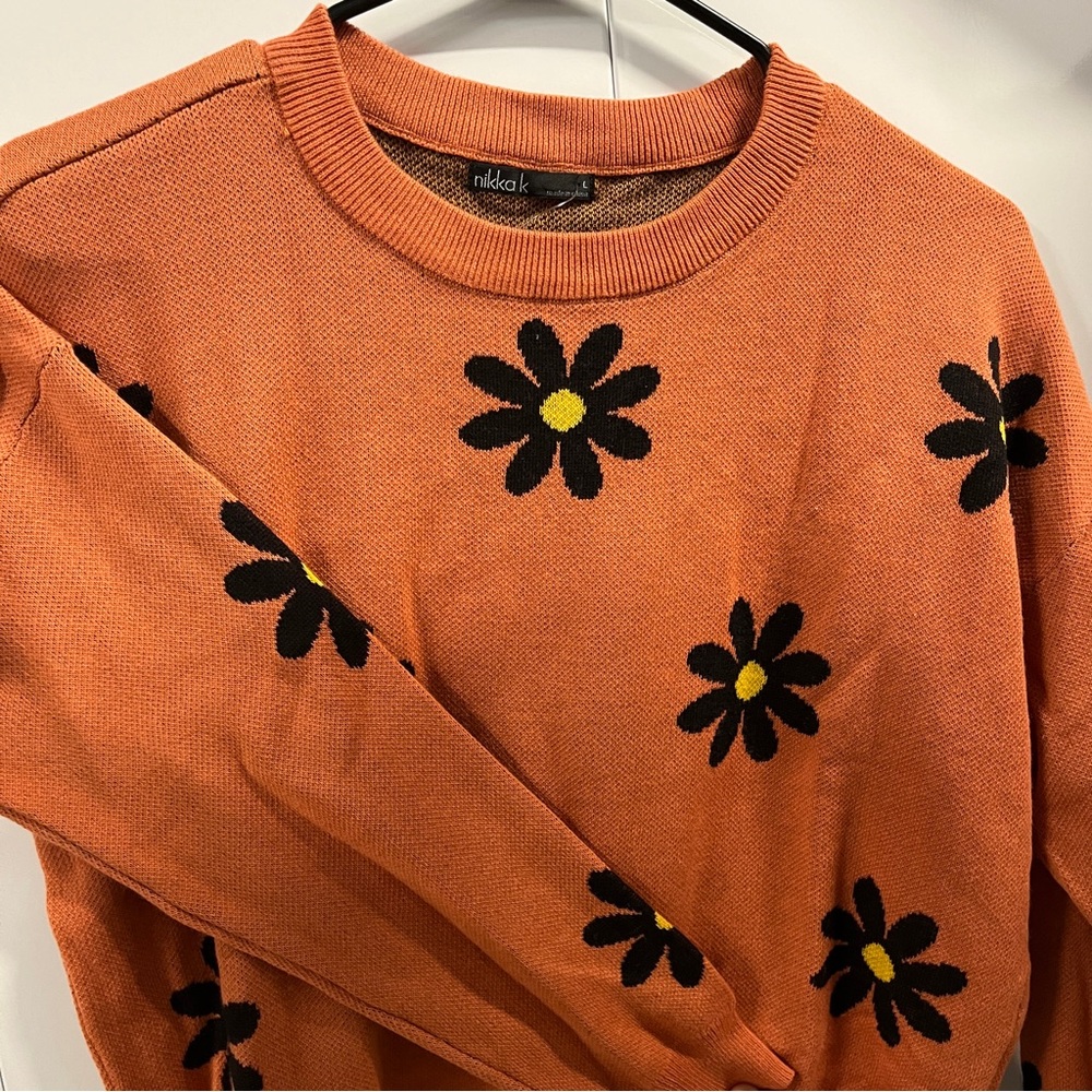 Orange sweater with daisy’s